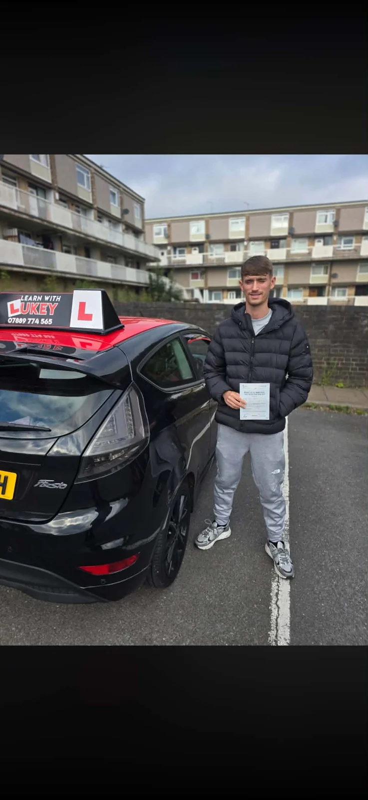 Billy celebrating a first-time driving test pass at Middlewood Test Centre