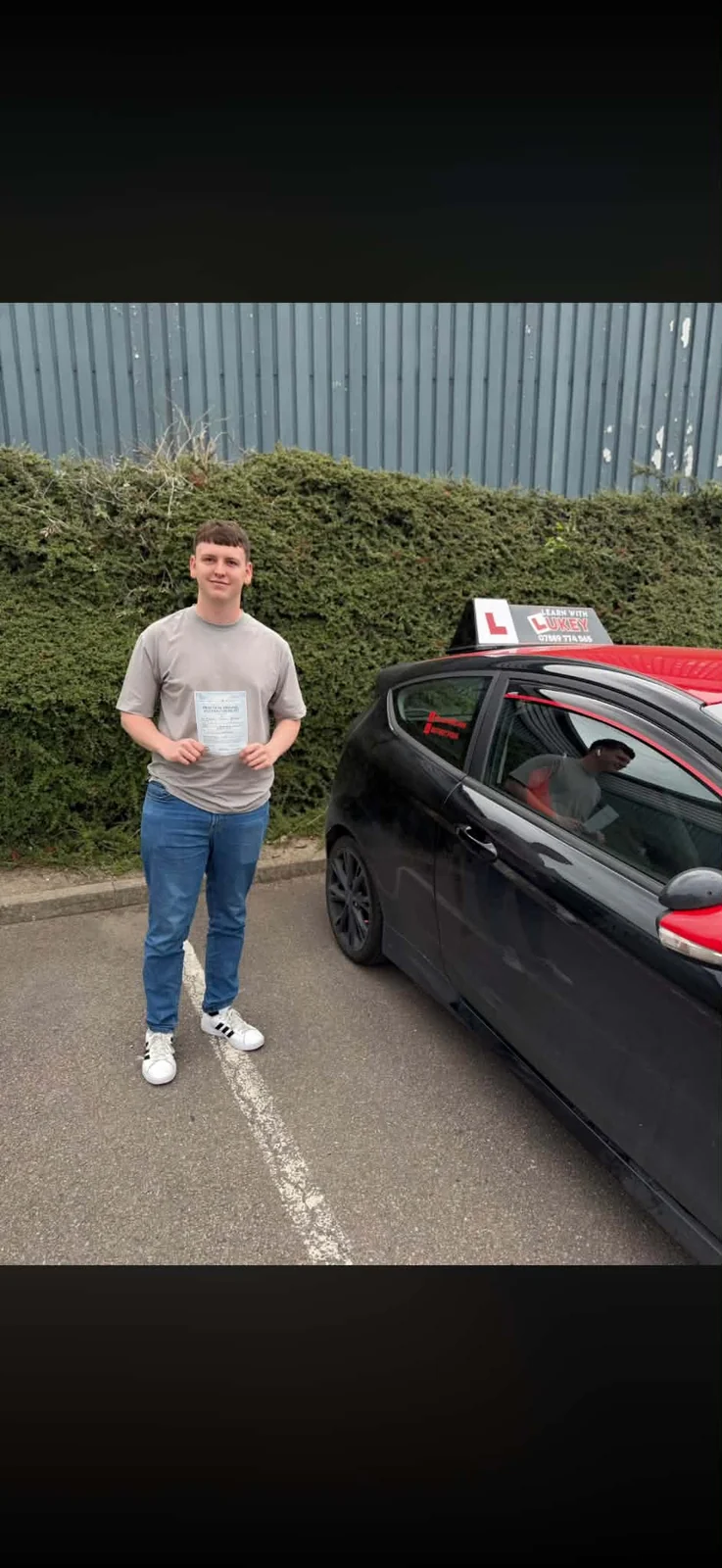 Brad celebrating a driving test pass at Rotherham Test Centre