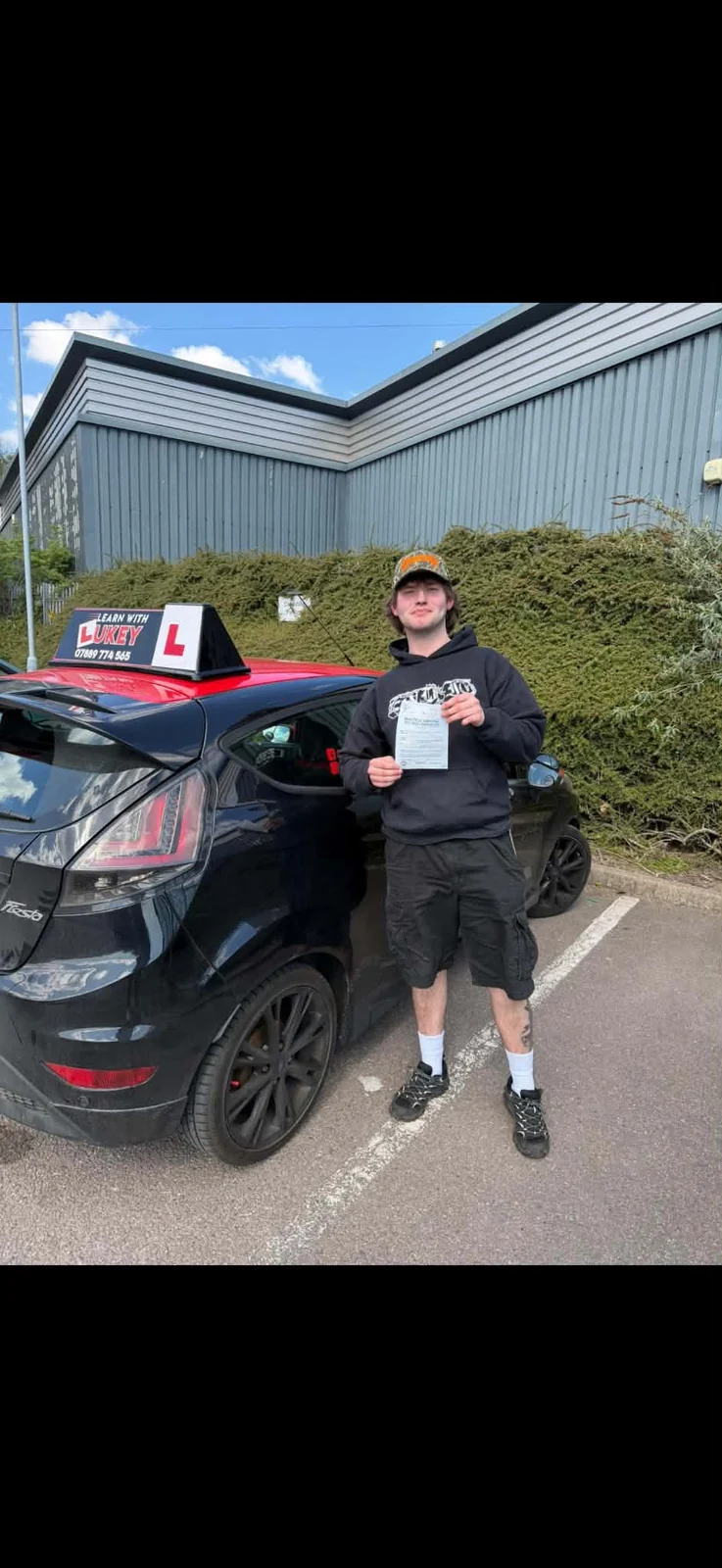 Theo celebrating a first-time driving test pass at Rotherham Test Centre